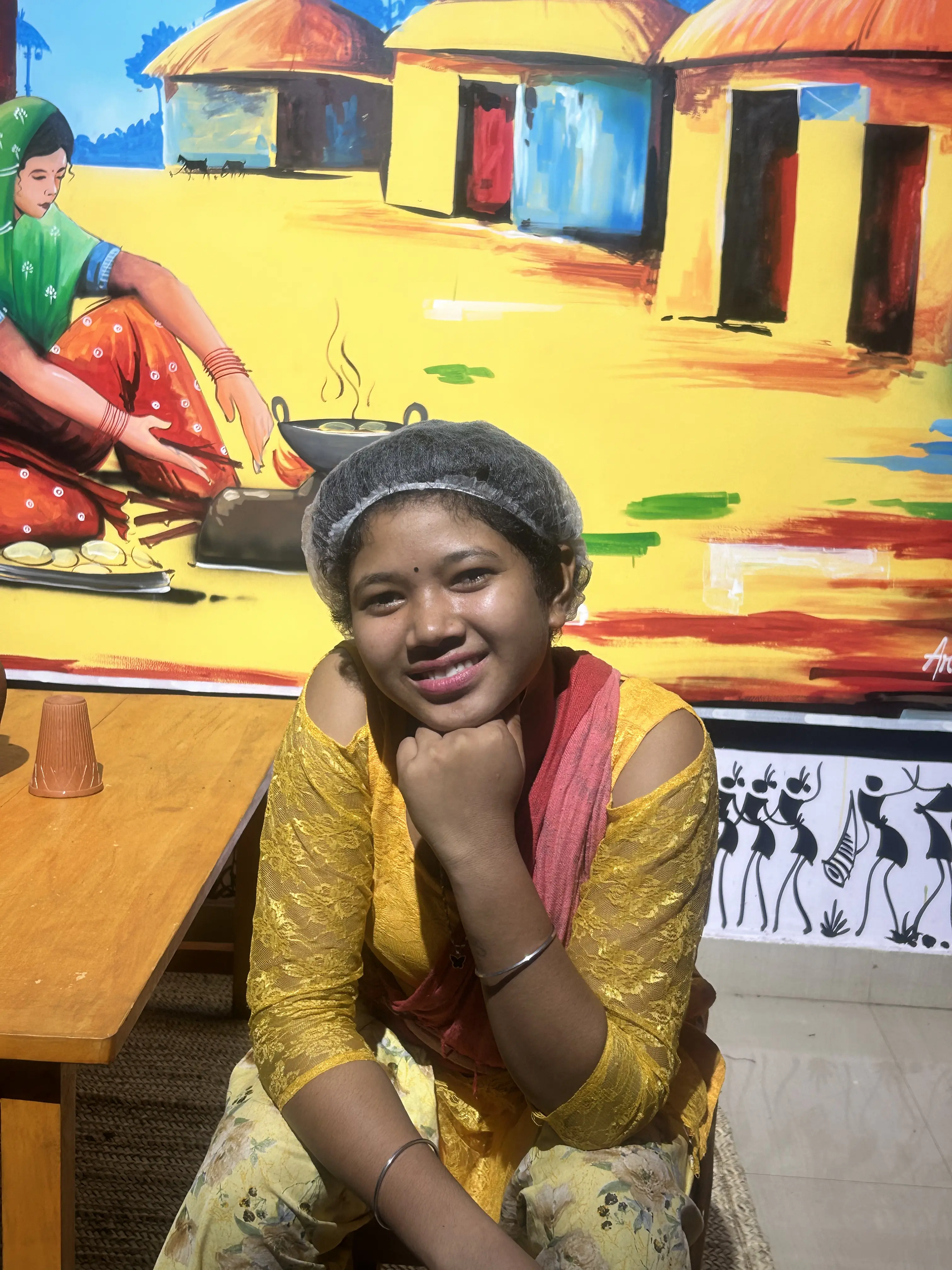 Woman in traditional tribal attire at JOMHA Restaurant